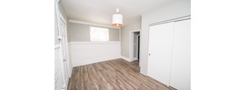 A room with a white door and a window.
