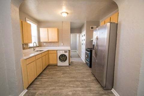 a kitchen with a refrigerator and a washing machine