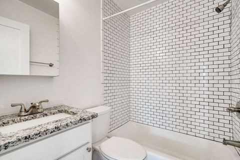 A white toilet sits next to a sink in a bathroom.