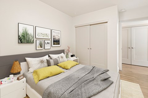 A bedroom with a bed, a nightstand, and a lamp.
