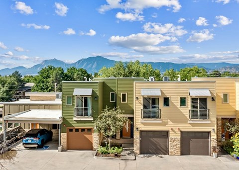 A row of houses with a mountain in the background.