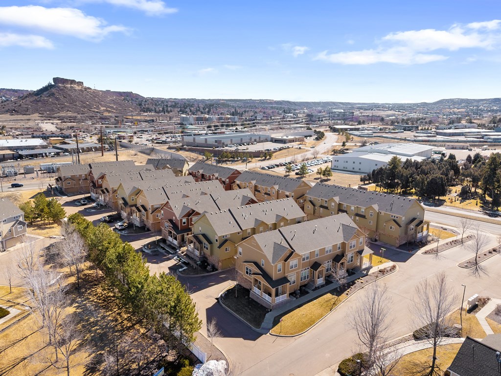 A large housing development with a mountain in the background.