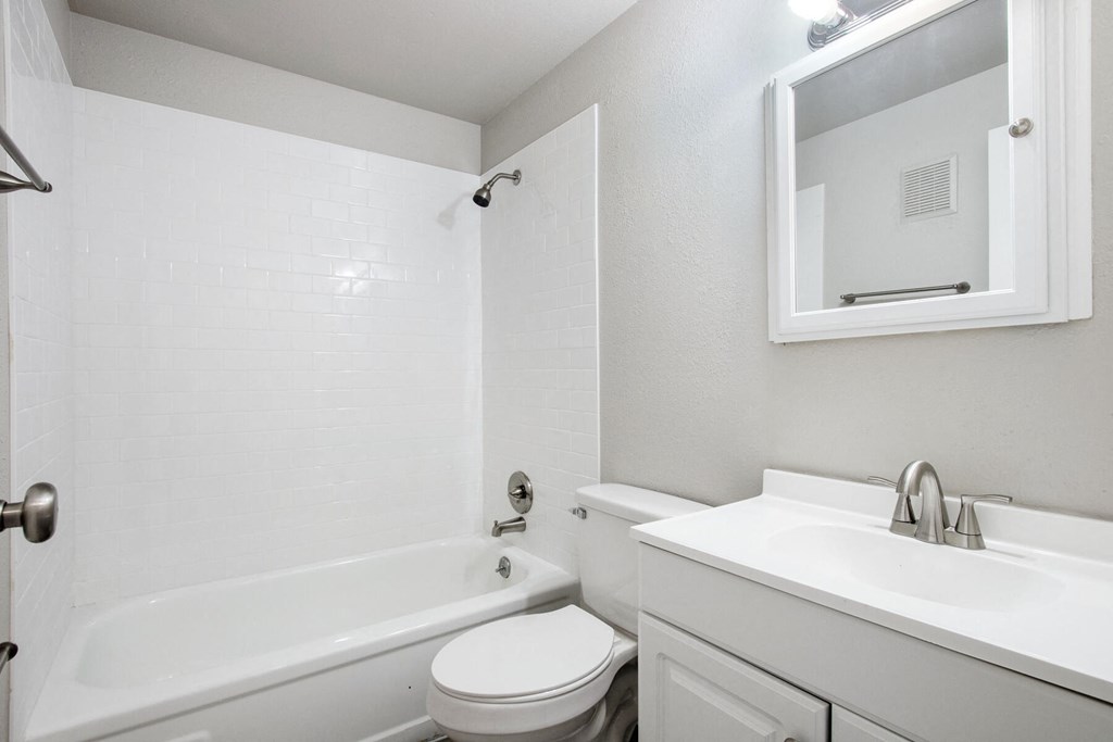 a white bathroom with a sink toilet and tub