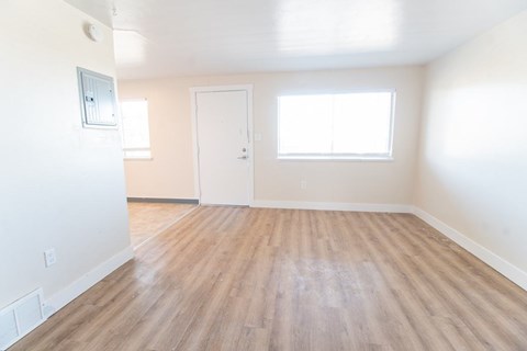 A room with wooden flooring and a window.