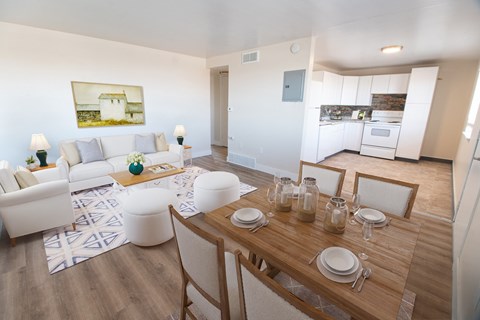 A dining table with chairs and a couch in a room.