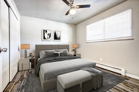 a bedroom with a bed and a ceiling fan
