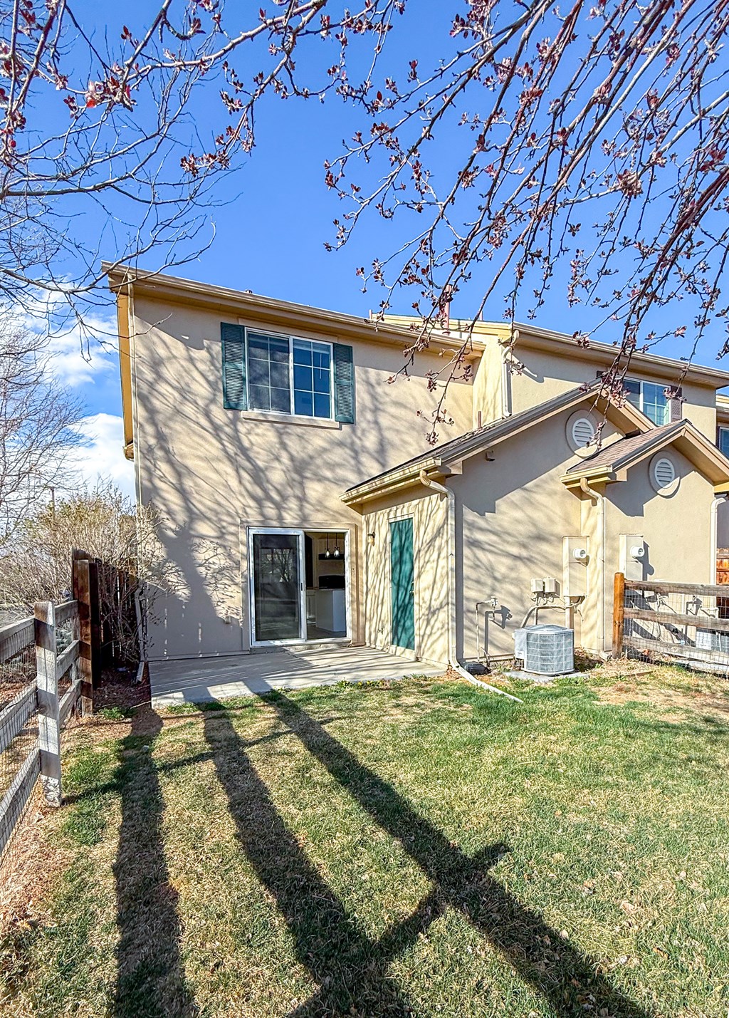 A house with a green door and a brown fence.