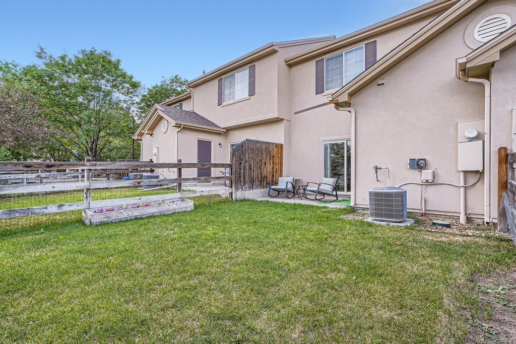 A house with a fenced in yard and a bicycle.