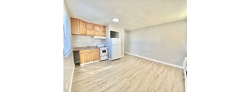 A kitchen with wooden cabinets and white appliances.