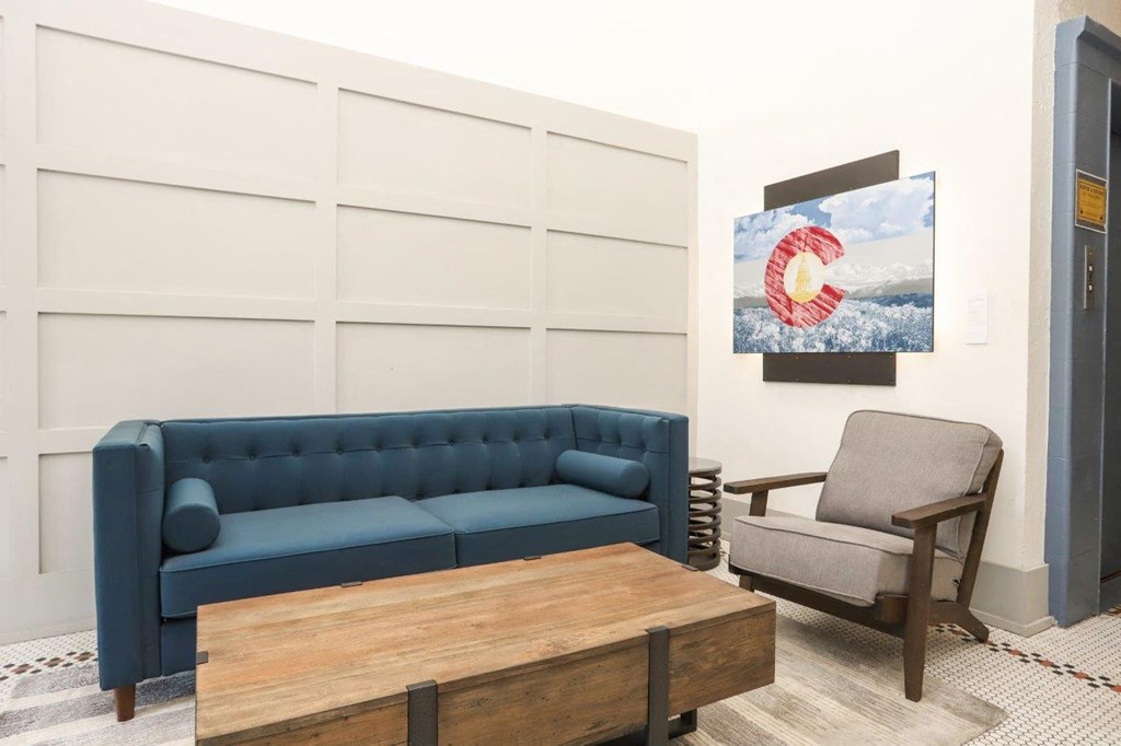 a living room with a blue couch and a chair