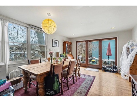 A dining room with a wooden table and chairs.