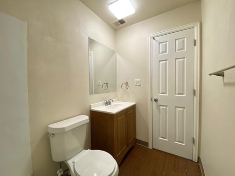 A white toilet sits next to a sink in a small bathroom.