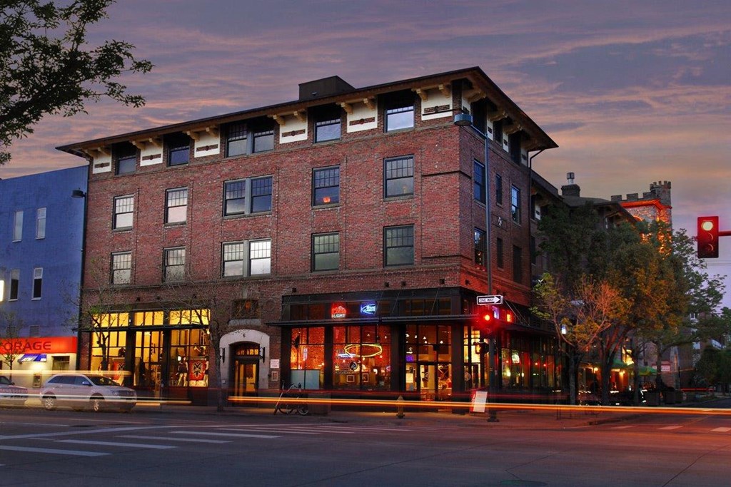 a large brick building with a traffic light in front of it