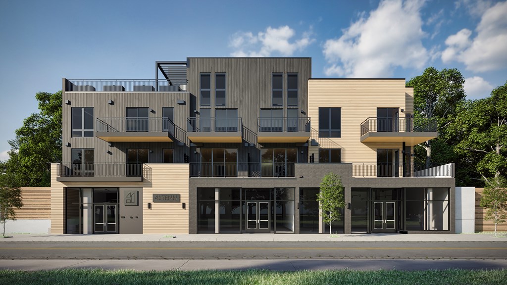 A modern multi-story building with balconies and large windows.