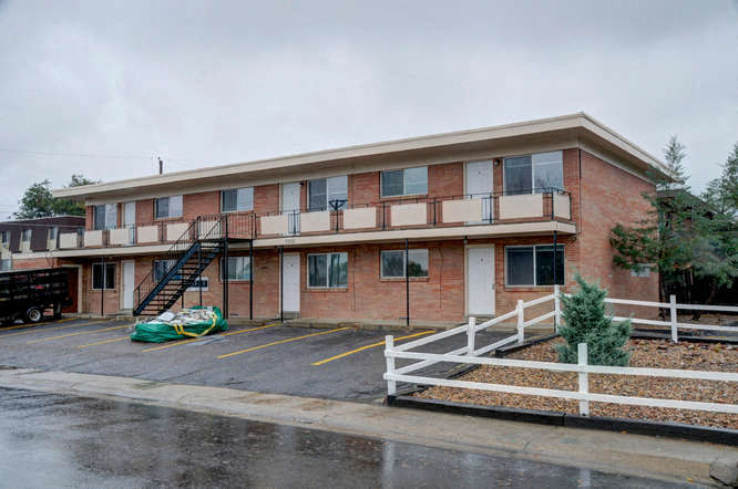 A building with a green tarp in front of it.
