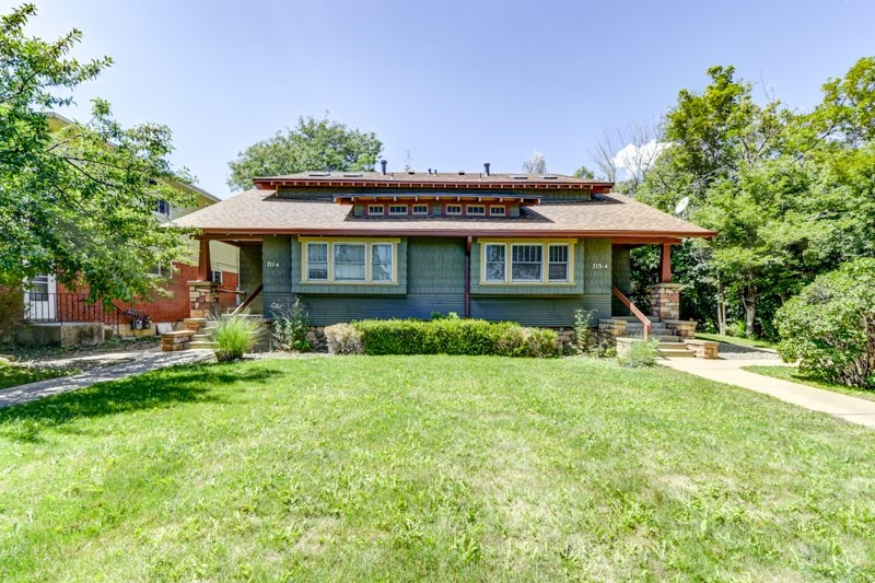 A house with a green lawn in front.