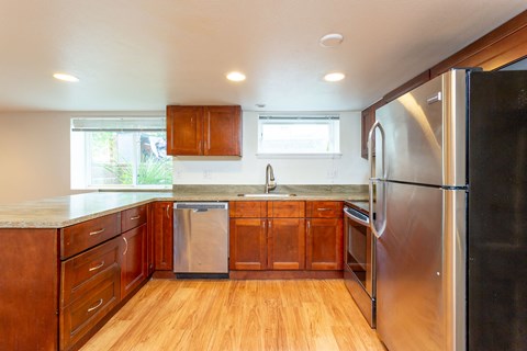 a kitchen with wooden cabinets and stainless steel appliances