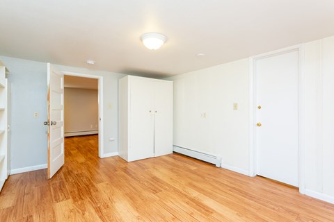 a renovated living room with wood floors and white walls