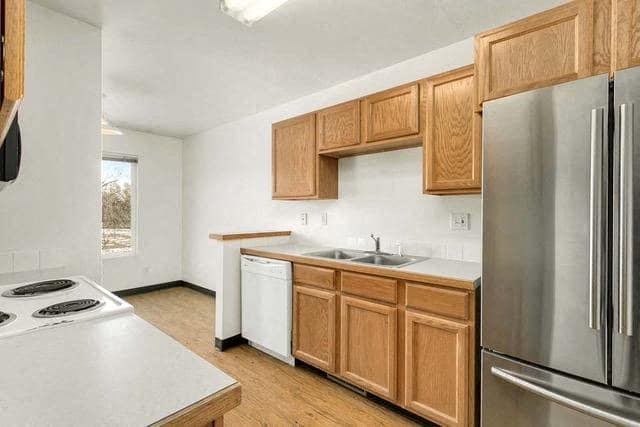 a kitchen with stainless steel appliances and wooden cabinets