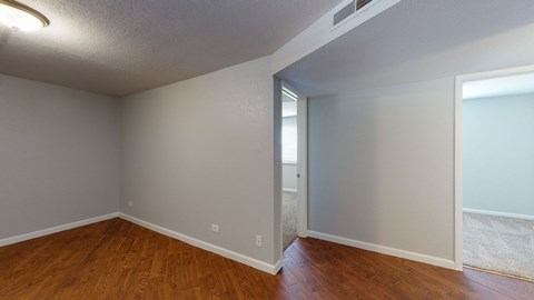 A room with wooden floors and white walls.