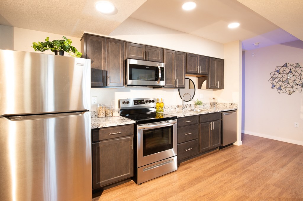 A modern kitchen with a stainless steel refrigerator and wooden cabinets.at 891 Exchange, Colorado