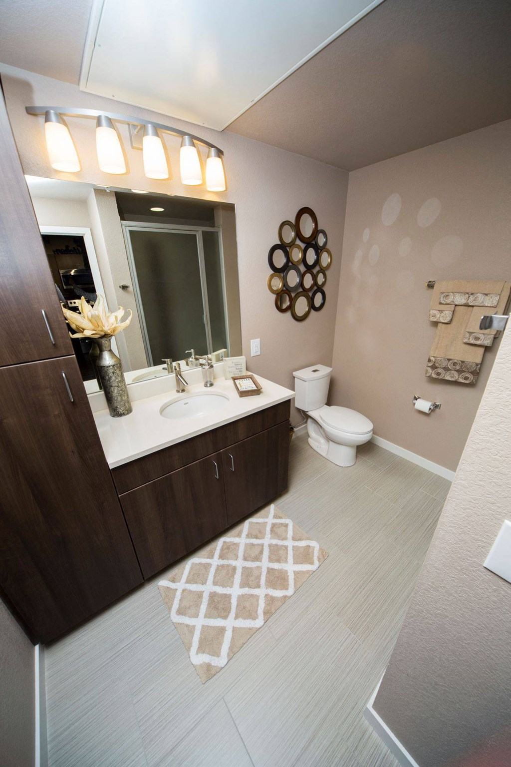 a bathroom with a sink toilet and a mirror