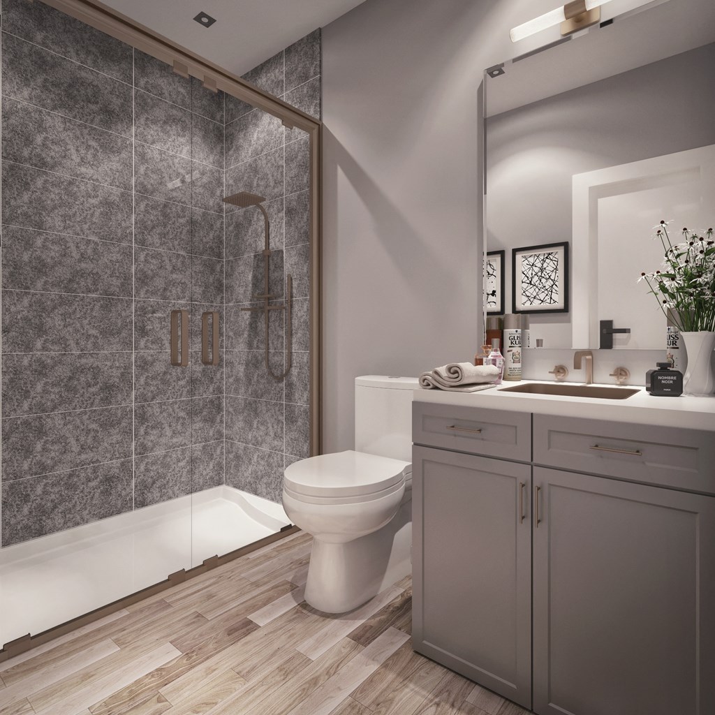 a bathroom with a toilet and a shower and a sink