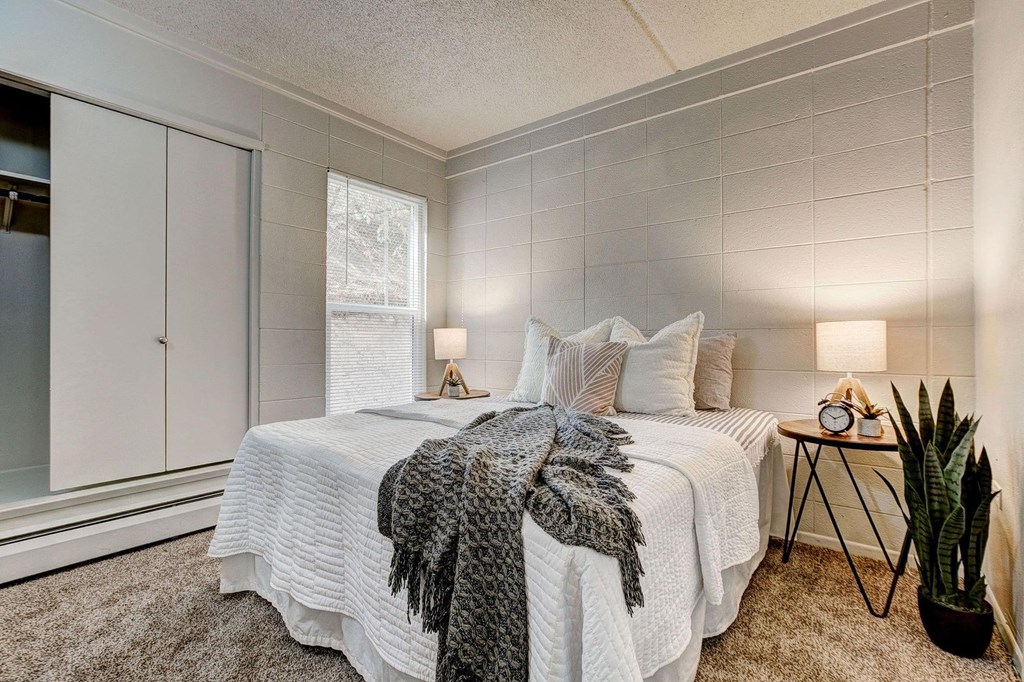 a bedroom with a bed and a window