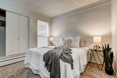 a bedroom with a bed and a window