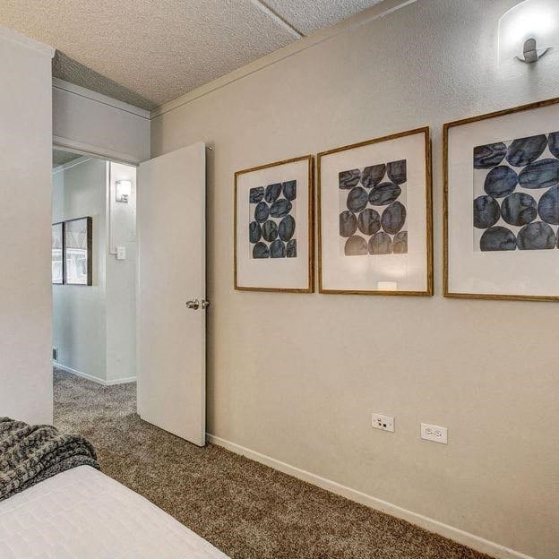 a bedroom with pictures on the wall and a bed