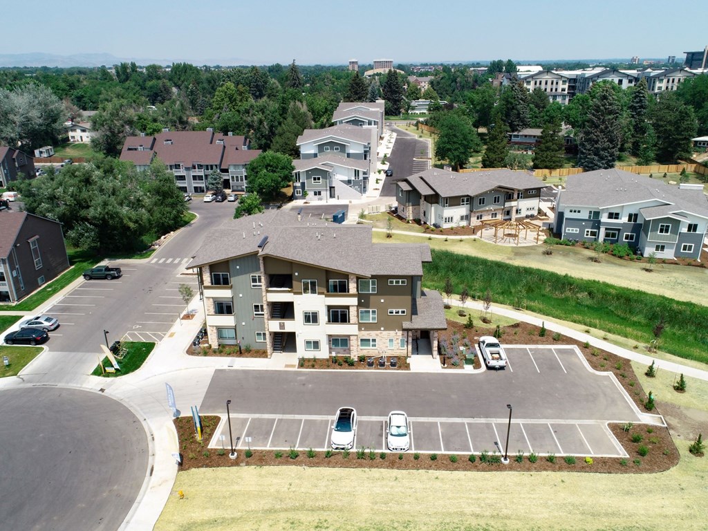 an aerial view of a neighborhood with houses and parking lot