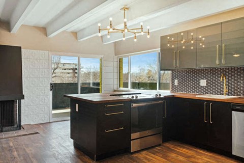 a kitchen with a sink and a large window