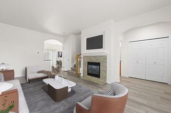 A living room with a fireplace and a television.