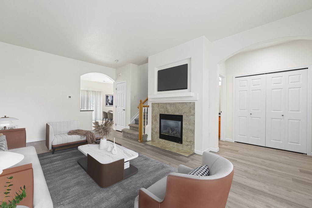 A living room with a fireplace and a television.