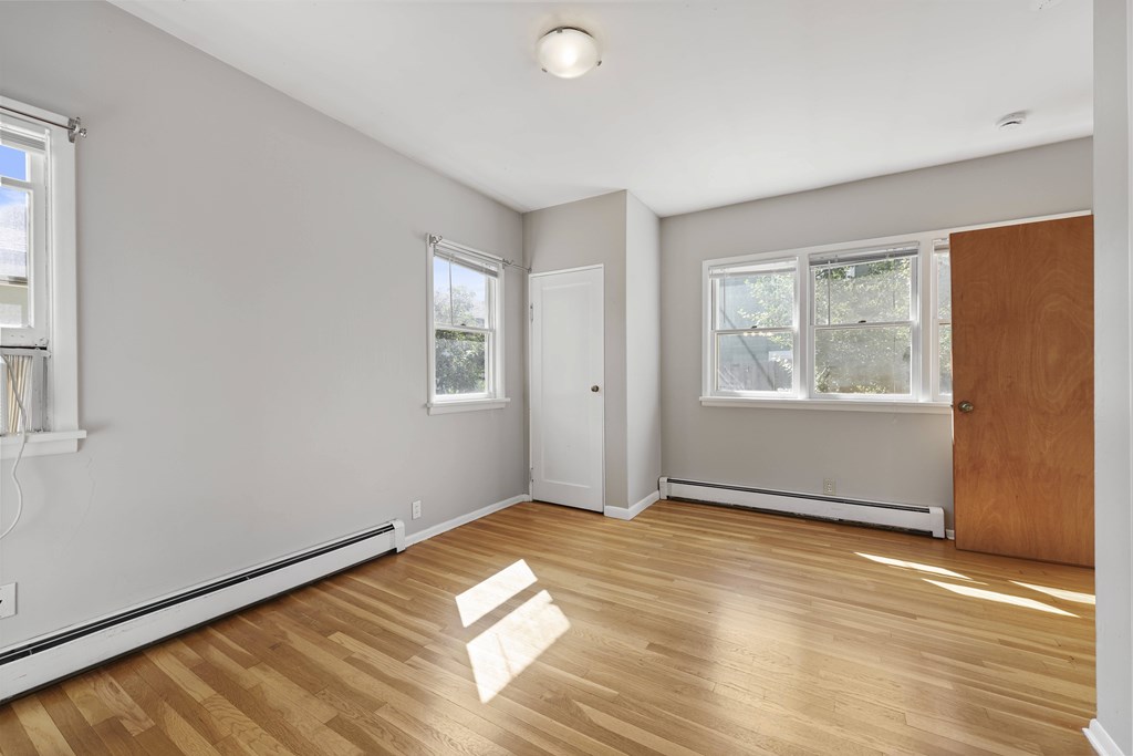 A room with wooden floors and white walls.