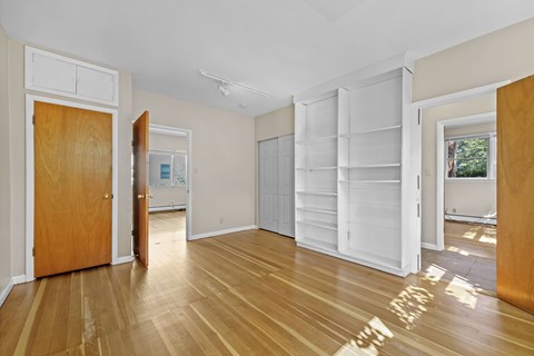 A room with a wooden floor and white walls.