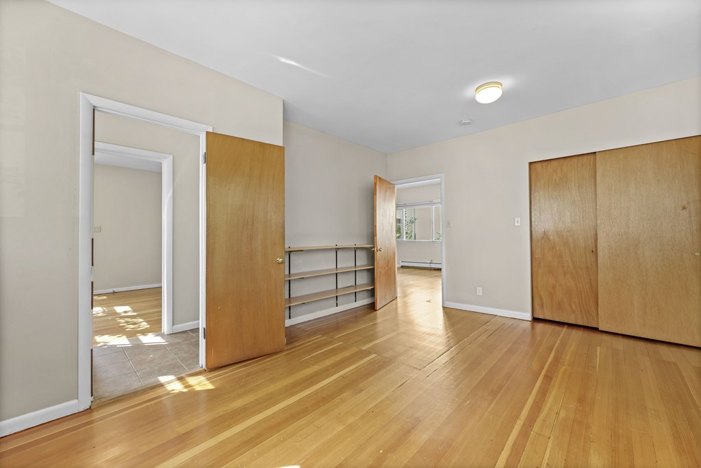 A room with wooden floors and white walls.