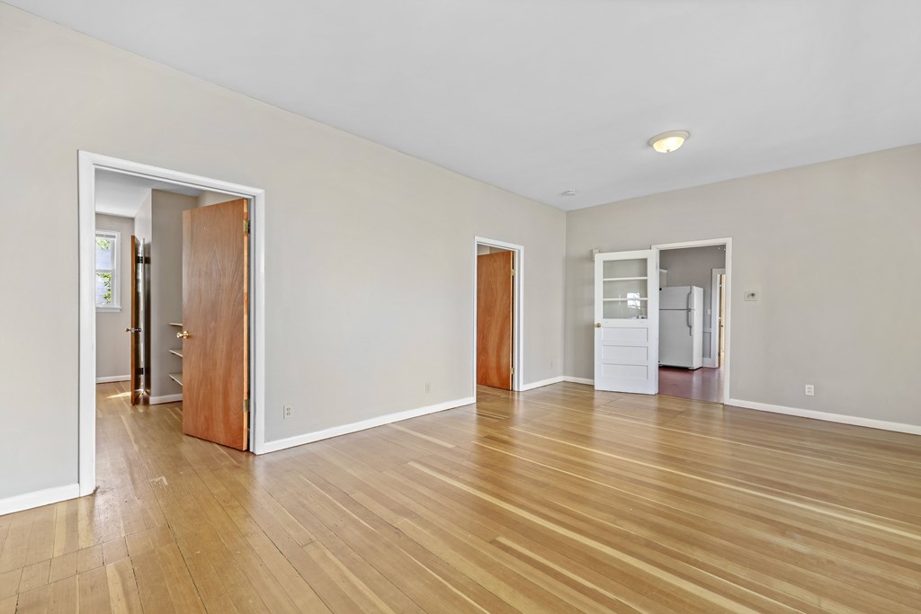 A room with wooden floors and white walls.