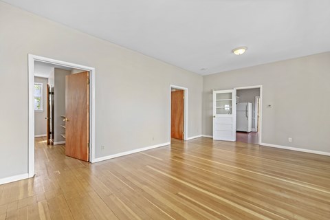 A room with wooden floors and white walls.