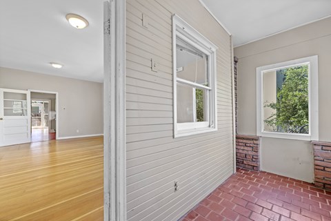 A room with a brick floor and a window.
