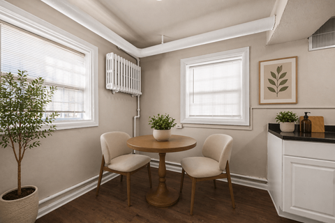 A small dining room with a table and chairs.