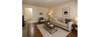 A living room with a couch, chair, and coffee table.