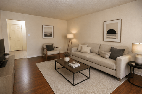 A living room with a couch, chair, and coffee table.