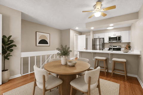 A dining room with a round table and chairs.