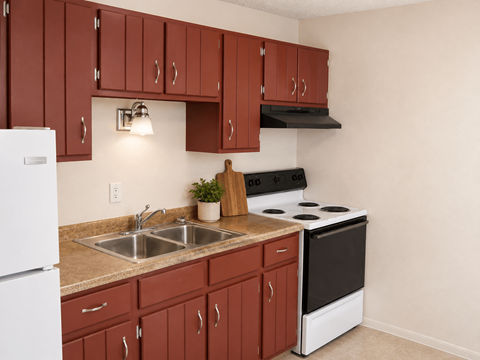 A kitchen with brown cabinets and a white refrigerator.