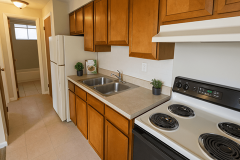 A kitchen with a white stove top oven and a white refrigerator.