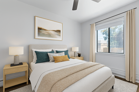 A bedroom with a large bed and a painting on the wall.