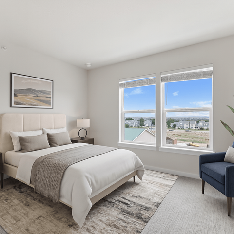 A bedroom with a large bed and a view of the outside through the window.