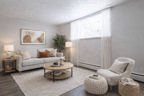 A living room with a grey couch, a white armchair, and a coffee table.