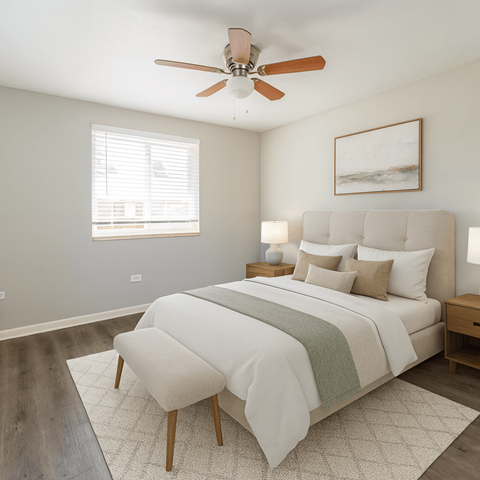 A bedroom with a large bed and a ceiling fan.
